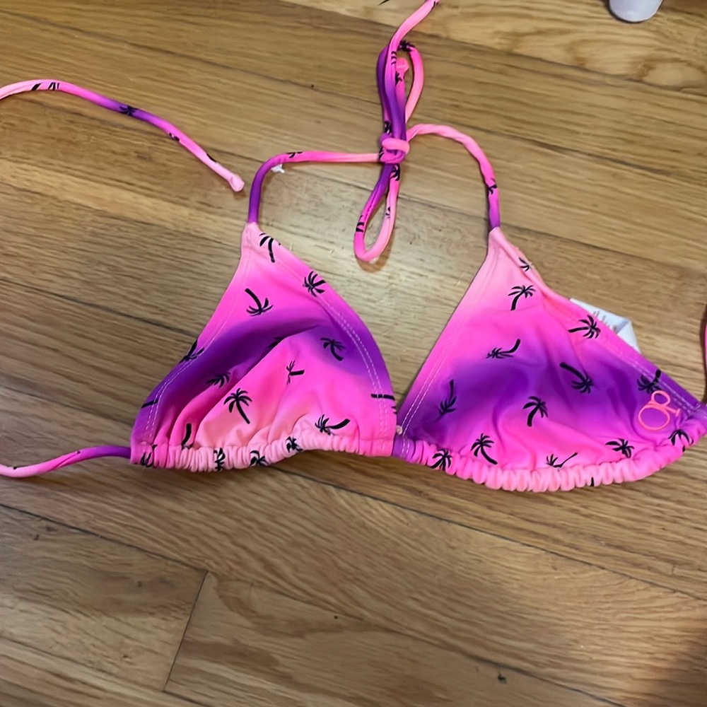 Pink and purple with black palm trees. Halter bikini top. Size M.